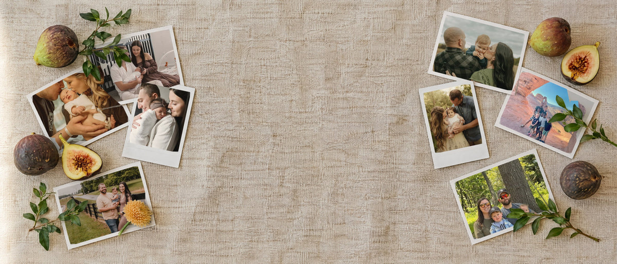Printed photos of FIG families on a linen tablecloth with fresh figs and greenery